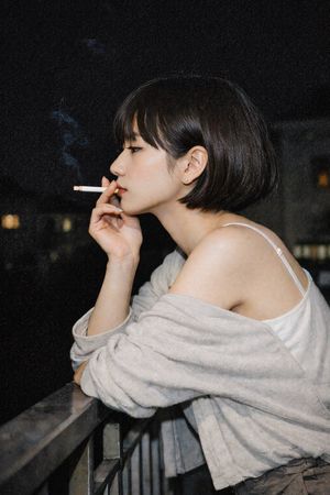 Cinematic Night Portrait of a Woman Smoking – GPT Image 2 prompt by Out Of Context Girls